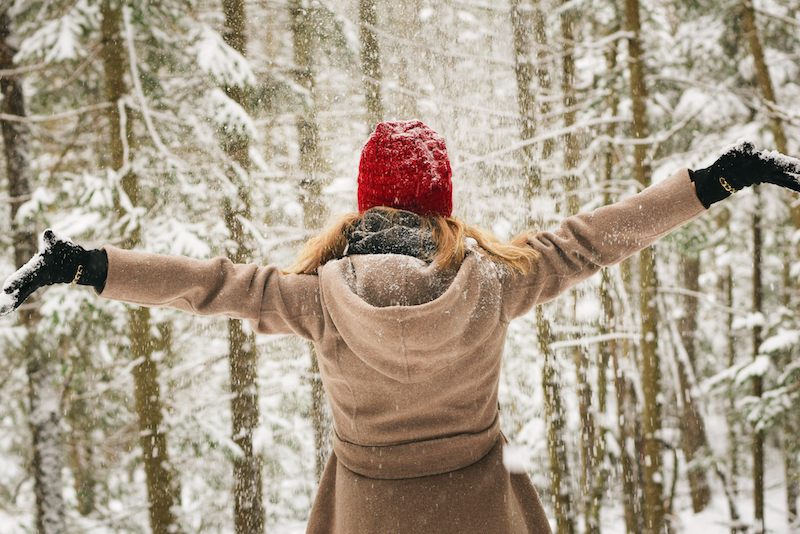 Image of woman embracing the winter, showing the liberation of accepting the sadness happening after the realization of a dream